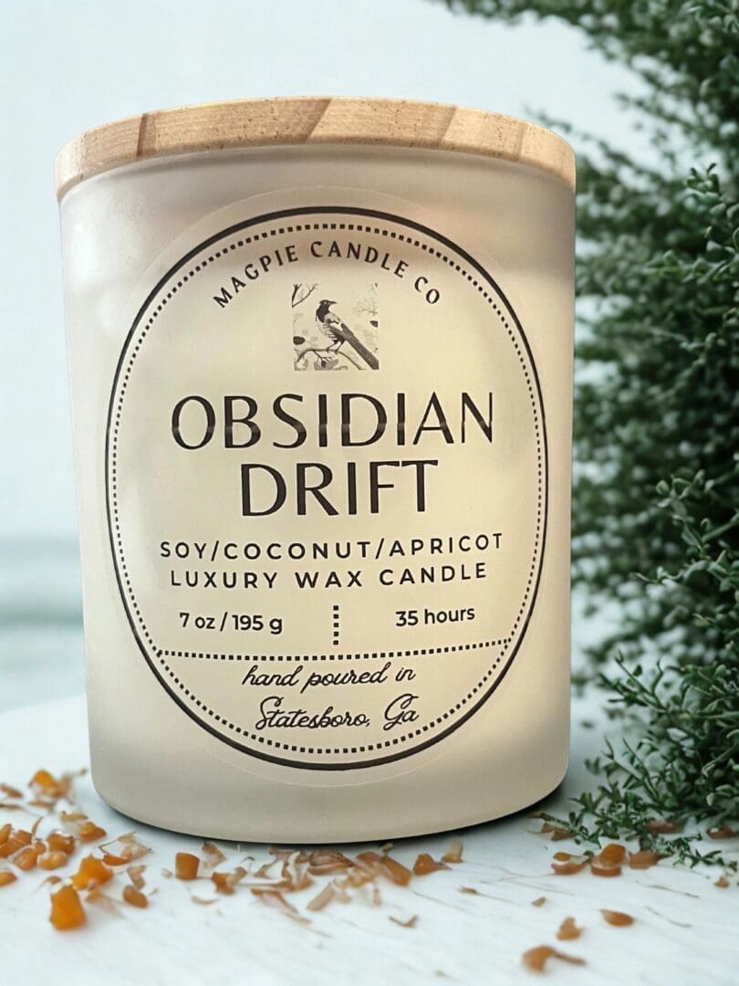 Candle labeled "Obsidian Drift" with plant background.