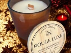 Luxury candle with Rouge Luxe label.