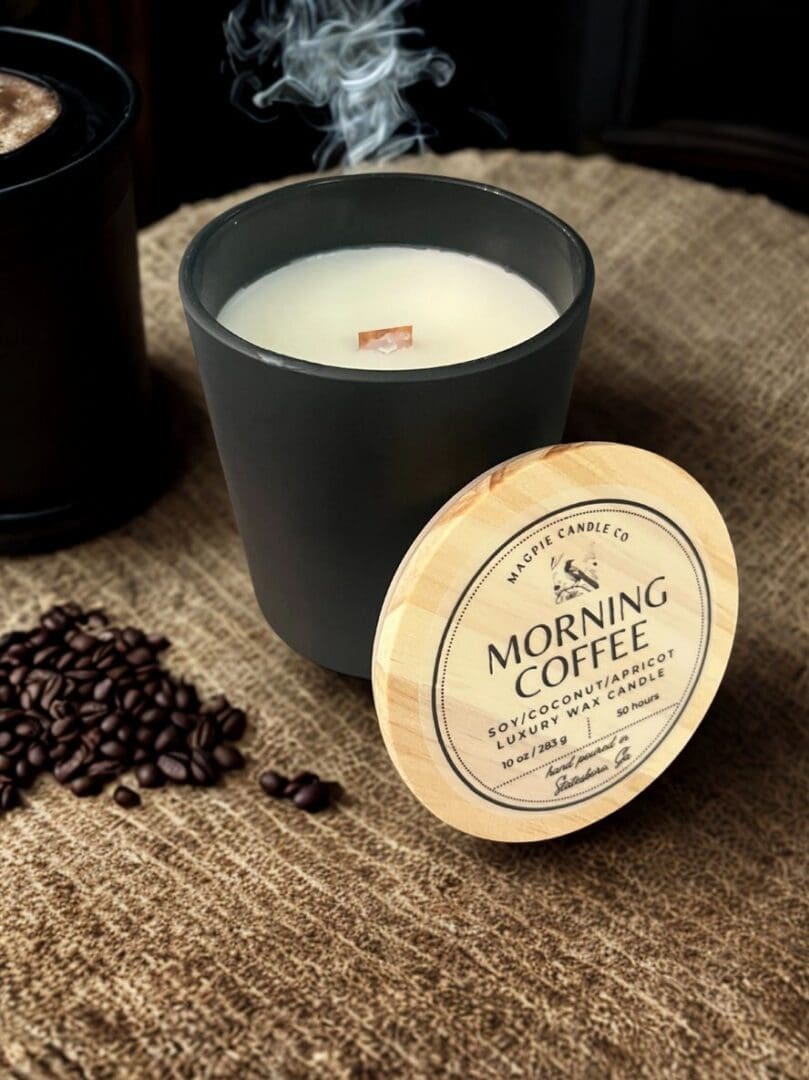 Coffee-scented candle with smoke and beans.
