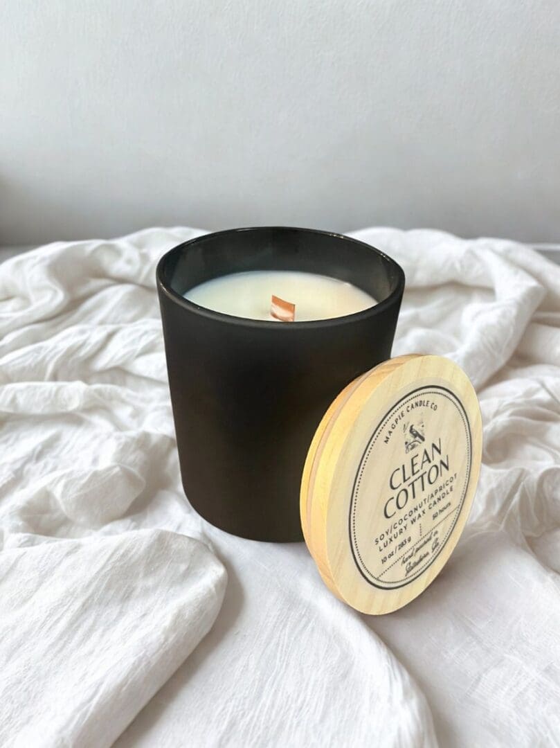 Black candle with "Clean Cotton" label.
